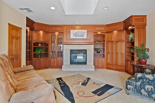 a living room with furniture a fireplace and a table