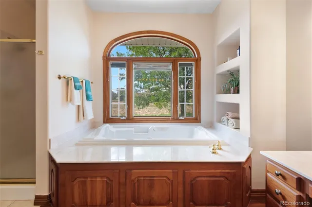 a bathroom with a sink a vanity and a large mirror