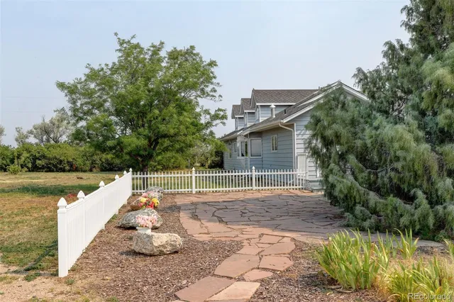 a view of a car parked in a yard