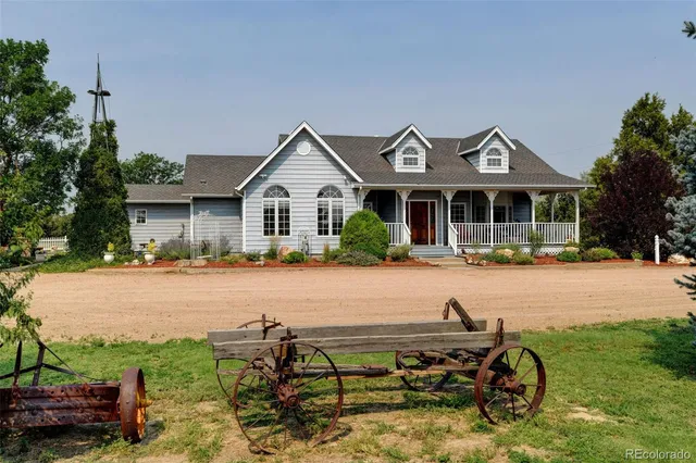 a front view of a house with patio furniture and garden