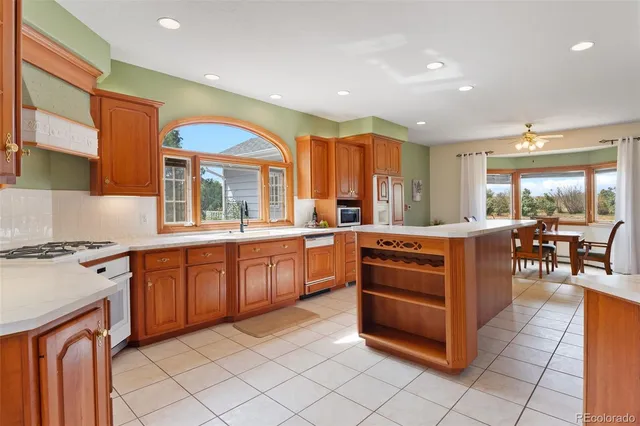 a kitchen with stainless steel appliances granite countertop a stove and a sink
