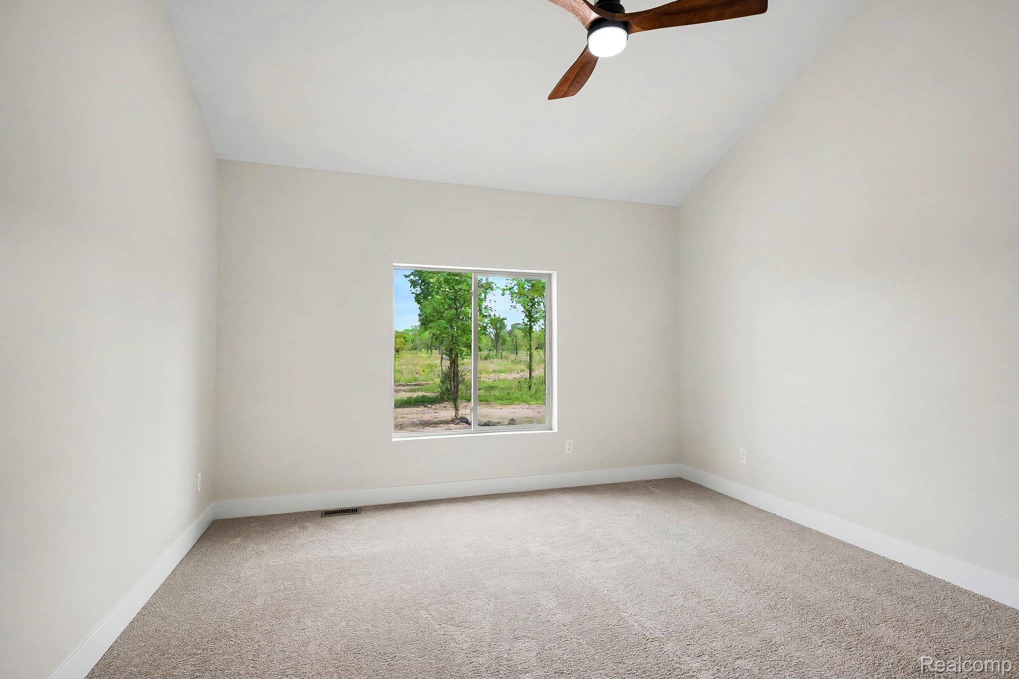 57560 Omo Road Ray, MI 48096 - Photo 17 of 44 Spacious room featuring vaulted ceilings, light neutral wall tones, and plush carpet flooring