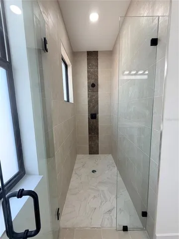 a bathroom with a tub and shower