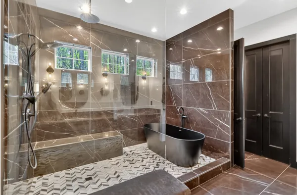 a bathroom with a bathtub and a shower