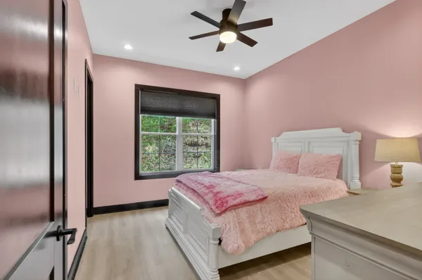 a bedroom with a large bed and a chandelier