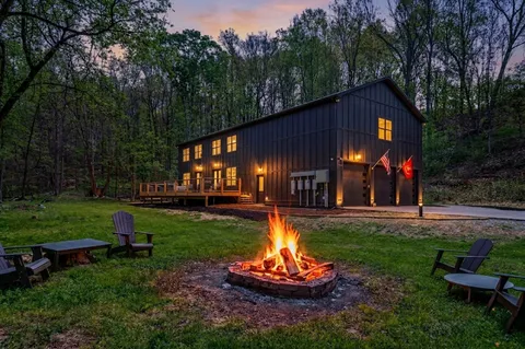 a view of a house with backyard and sitting area