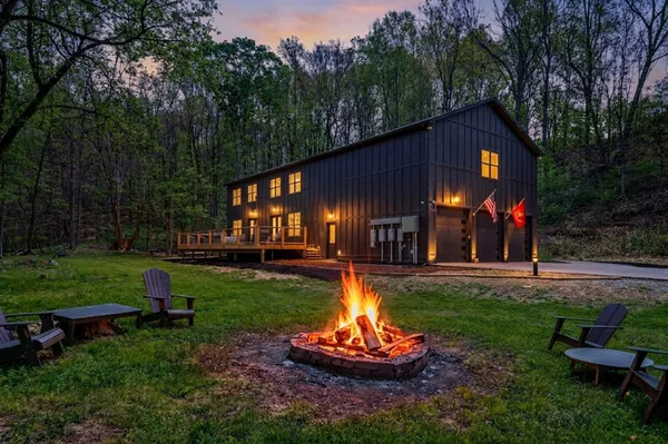 a view of a house with backyard and sitting area