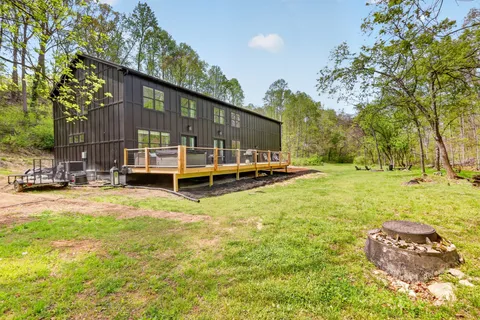 a view of a house with backyard and sitting area
