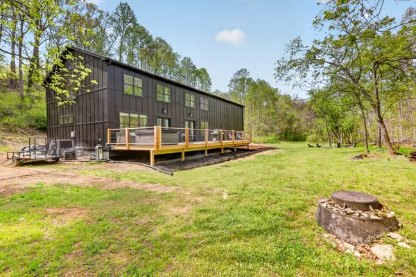 a view of a house with backyard and sitting area