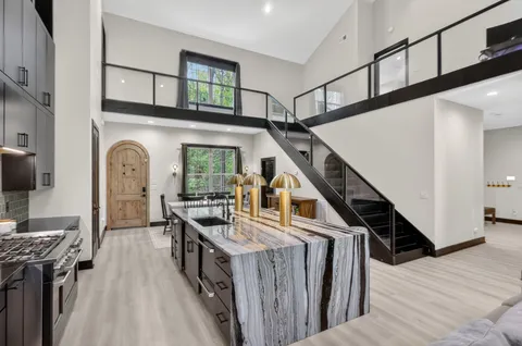 a view of entryway and hall with wooden floor