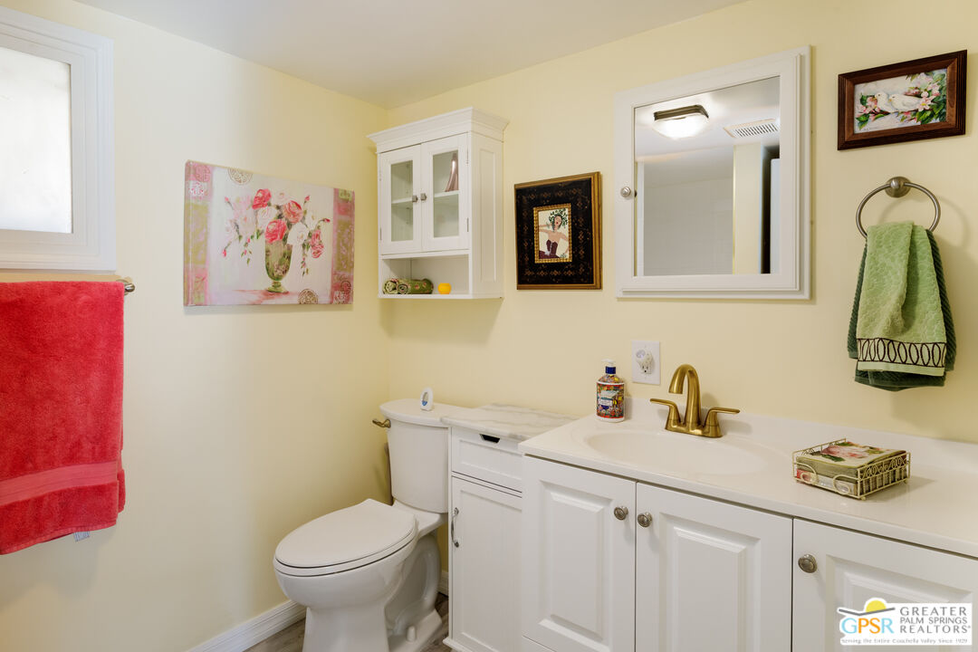 157 Caravan Street Palm Springs, CA 92264 - Photo 21 of 38 a bathroom with a toilet sink and mirror