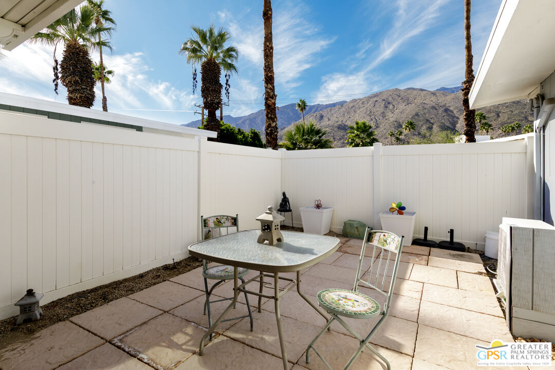157 Caravan Street Palm Springs, CA 92264 - Photo 25 of 38 a view of table and chair with potted plants