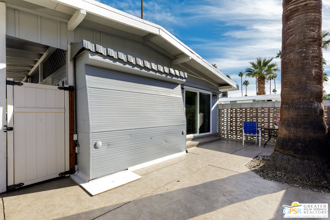 157 Caravan Street Palm Springs, CA 92264 - Photo 27 of 38 a view of a garage with wooden wall and roof