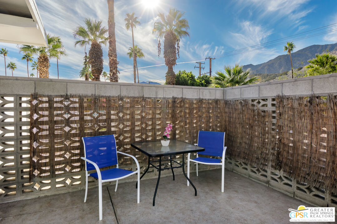 157 Caravan Street Palm Springs, CA 92264 - Photo 29 of 38 a balcony with table and chairs
