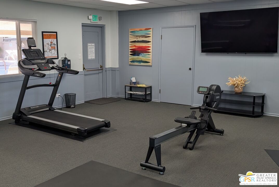 157 Caravan Street Palm Springs, CA 92264 - Photo 35 of 38 a room with gym equipment and a flat screen tv