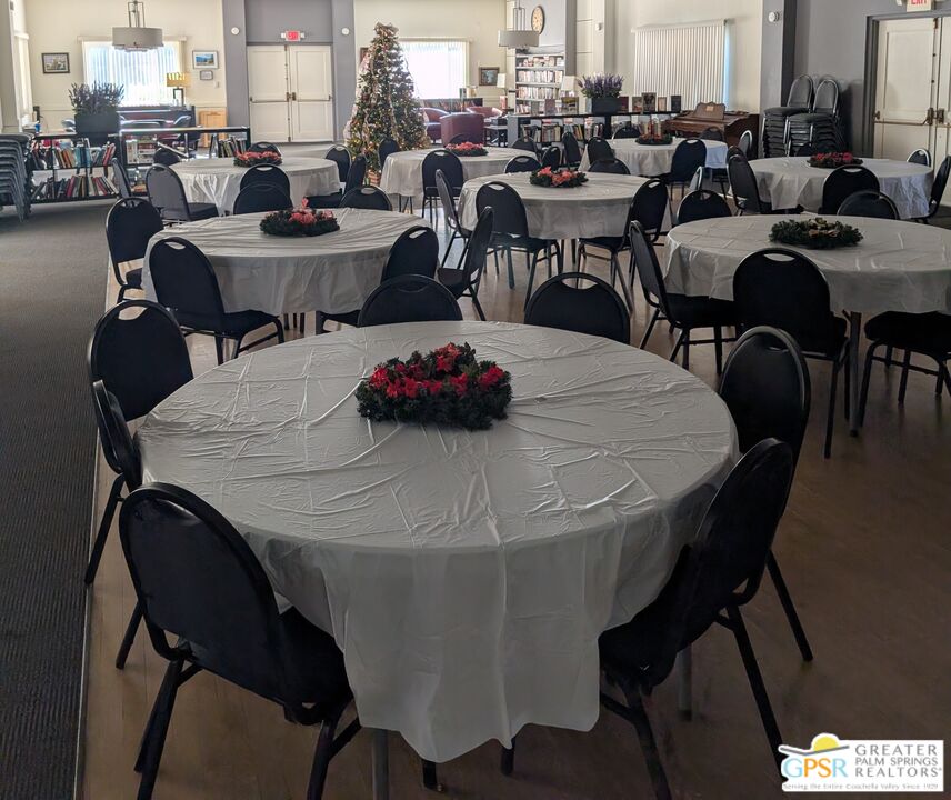 157 Caravan Street Palm Springs, CA 92264 - Photo 36 of 38 a view of a dining room with furniture and a chandelier