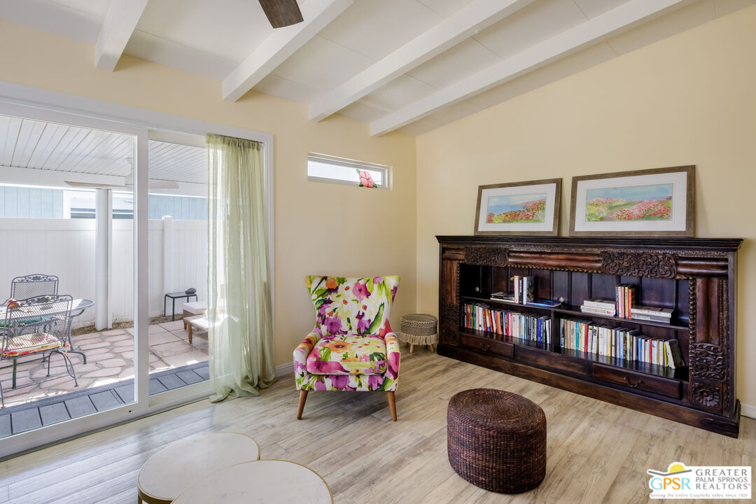 157 Caravan Street Palm Springs, CA 92264 - Photo 9 of 38 a living room with lots of furniture and baby toys