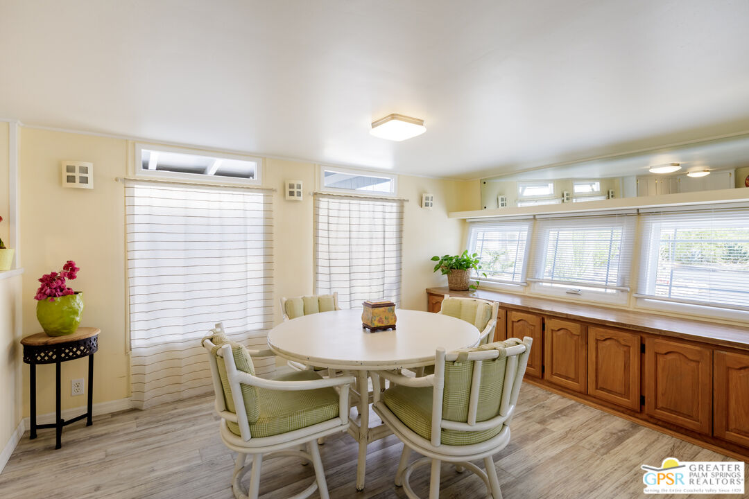 157 Caravan Street Palm Springs, CA 92264 - Photo 10 of 38 a view of a dining room with furniture and wooden floor