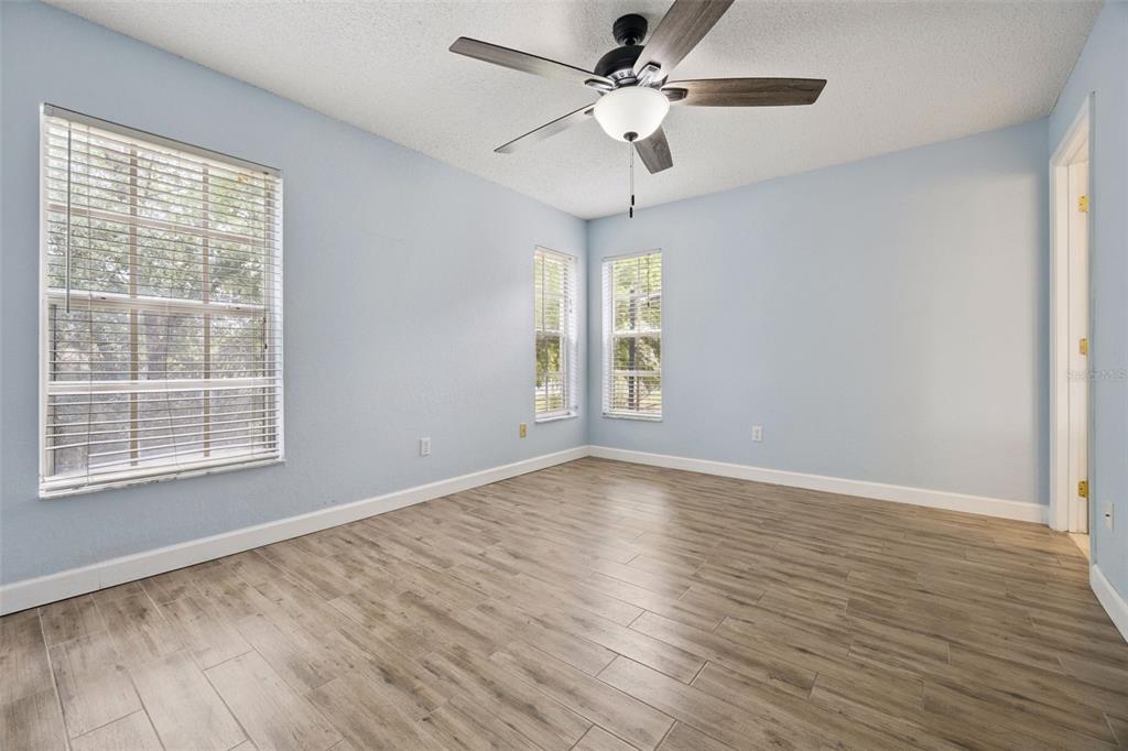 124 Diamond Ridge Boulevard Auburndale, FL 33823 - Photo 11 of 20 wooden floor in an empty room with a window