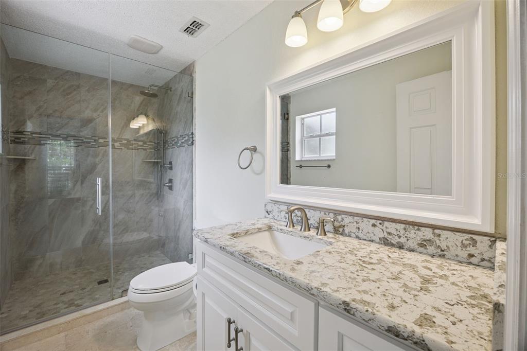 124 Diamond Ridge Boulevard Auburndale, FL 33823 - Photo 12 of 20 a bathroom with a granite countertop sink a toilet and shower