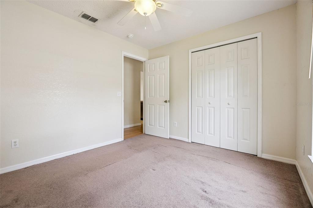 124 Diamond Ridge Boulevard Auburndale, FL 33823 - Photo 13 of 20 an empty room with a ceiling fan and a window