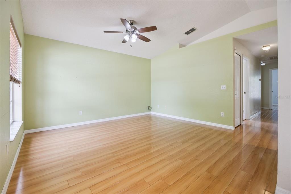 124 Diamond Ridge Boulevard Auburndale, FL 33823 - Photo 4 of 20 wooden floor in an empty room with a window