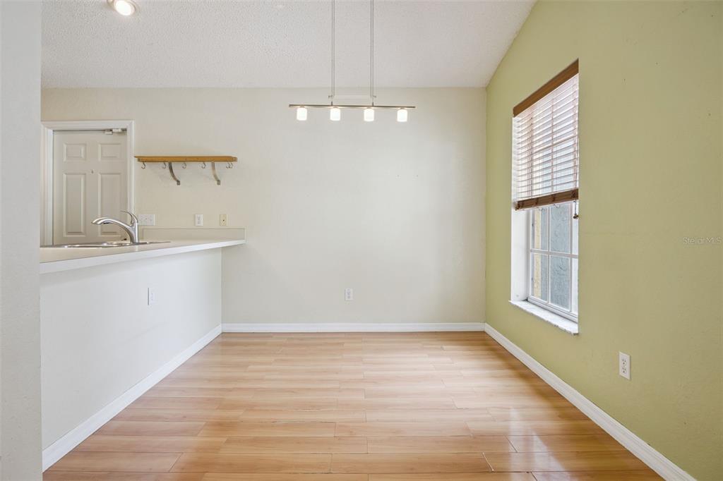 124 Diamond Ridge Boulevard Auburndale, FL 33823 - Photo 5 of 20 a view of a kitchen with wooden floor and a sink