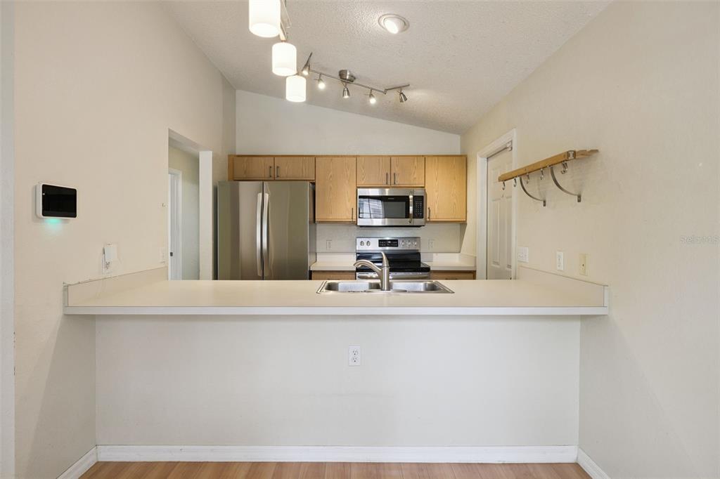 124 Diamond Ridge Boulevard Auburndale, FL 33823 - Photo 8 of 20 a kitchen with kitchen island a sink stainless steel appliances and cabinets