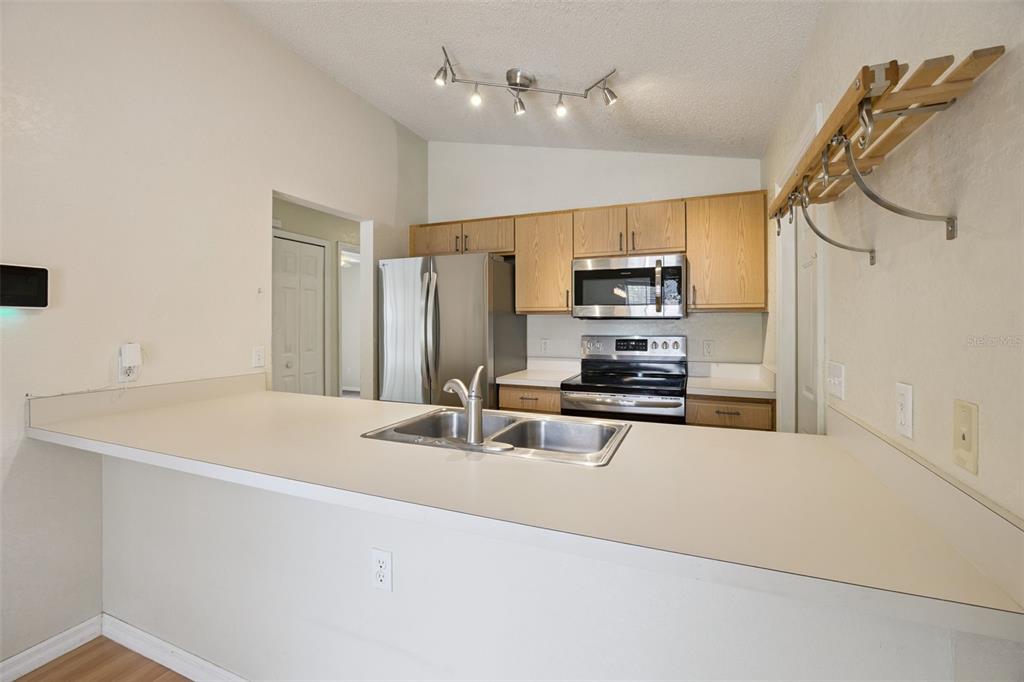 124 Diamond Ridge Boulevard Auburndale, FL 33823 - Photo 9 of 20 a kitchen with stainless steel appliances a stove sink and microwave