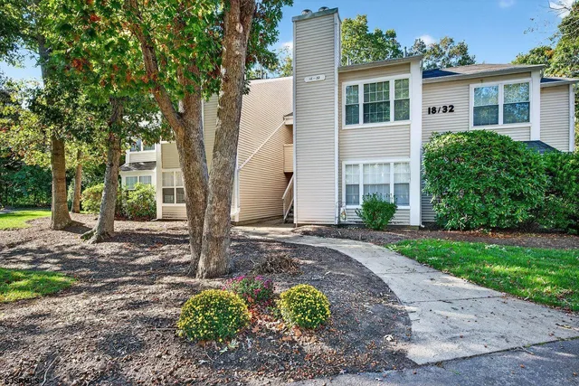 a view of a house with yard and a tree