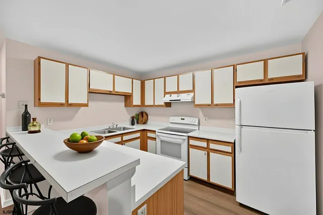 a kitchen with a sink appliances and cabinets