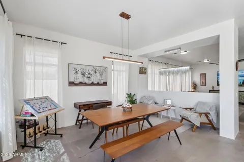 a dining room with furniture and window