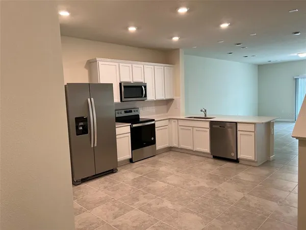 a kitchen with stainless steel appliances a refrigerator and a sink