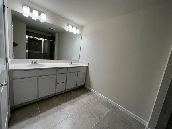 a white toilet sitting next to a shower