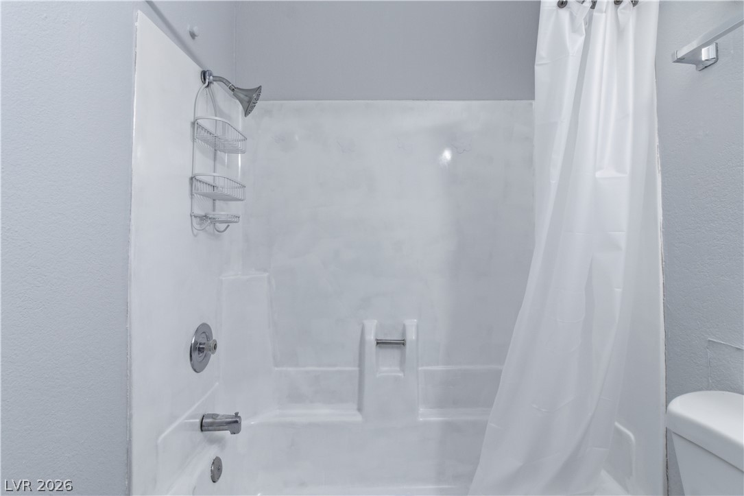 2221 West Bonanza Road, Unit 28 Las Vegas, NV 89106 - Photo 9 of 15 This bathroom features a sleek, combined shower and tub, offering a practical and refreshed design.
