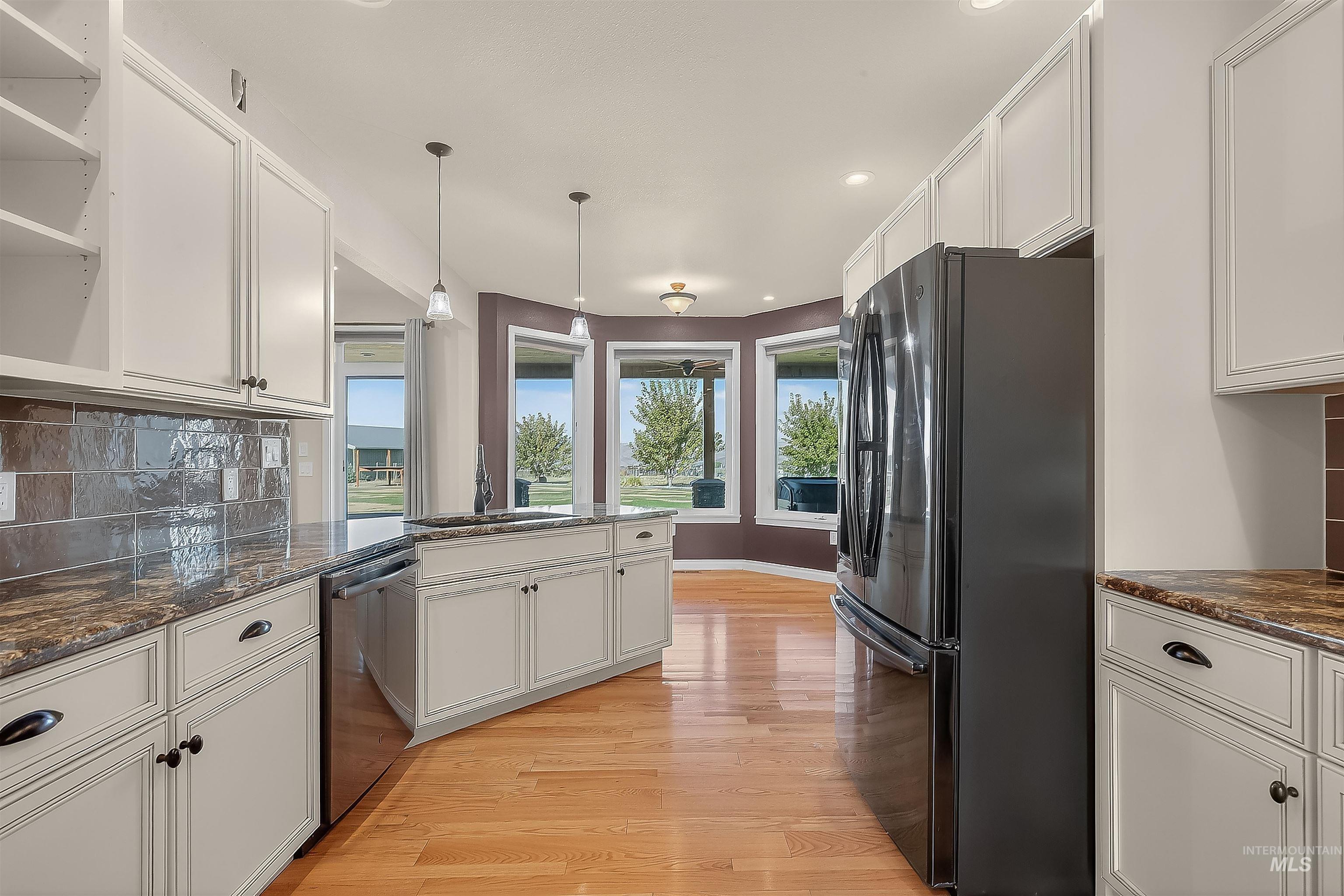 2233 Burrell Avenue Lewiston, ID 83501 - Photo 12 of 48 Kitchen with decorative backsplash, freestanding refrigerator, white cabinetry, and recessed lighting