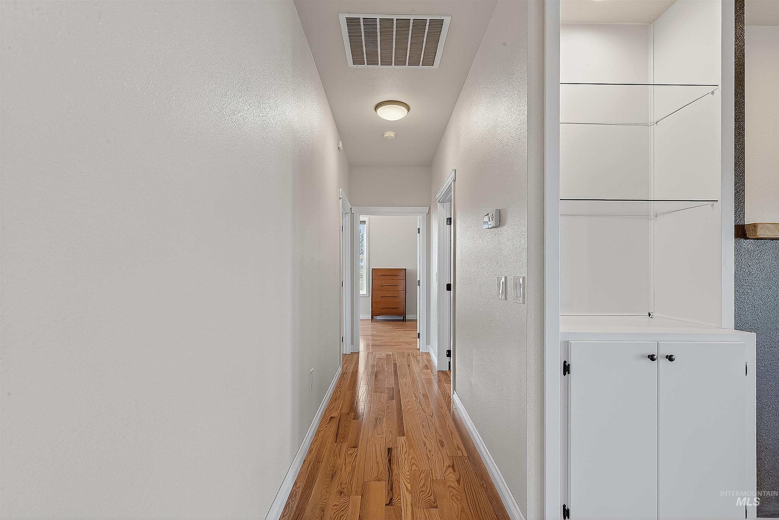 2233 Burrell Avenue Lewiston, ID 83501 - Photo 24 of 48 Corridor with light wood-style flooring and a textured wall