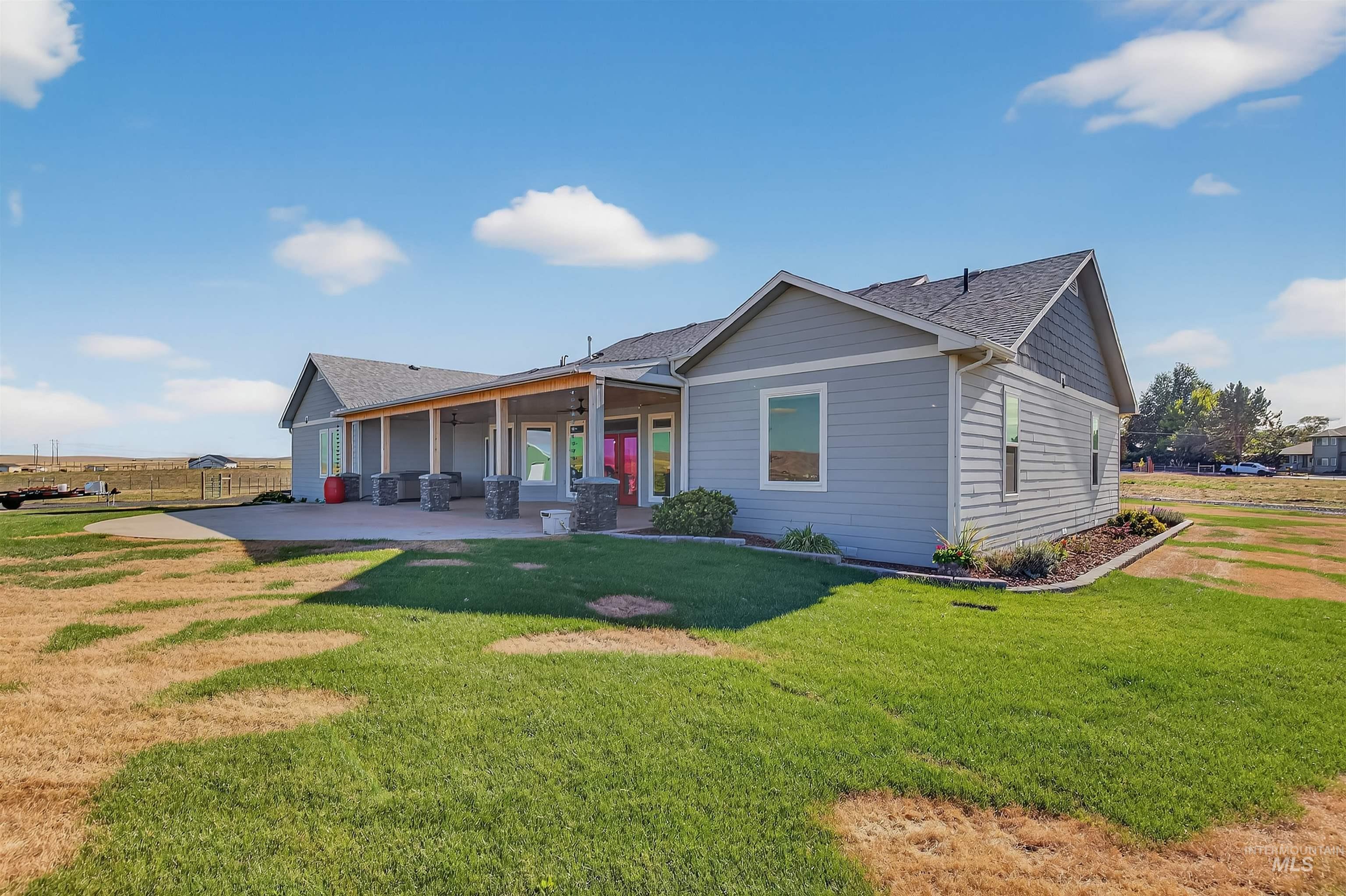2233 Burrell Avenue Lewiston, ID 83501 - Photo 3 of 48 Back of house featuring a shingled roof, a patio area, a yard, and a ceiling fan