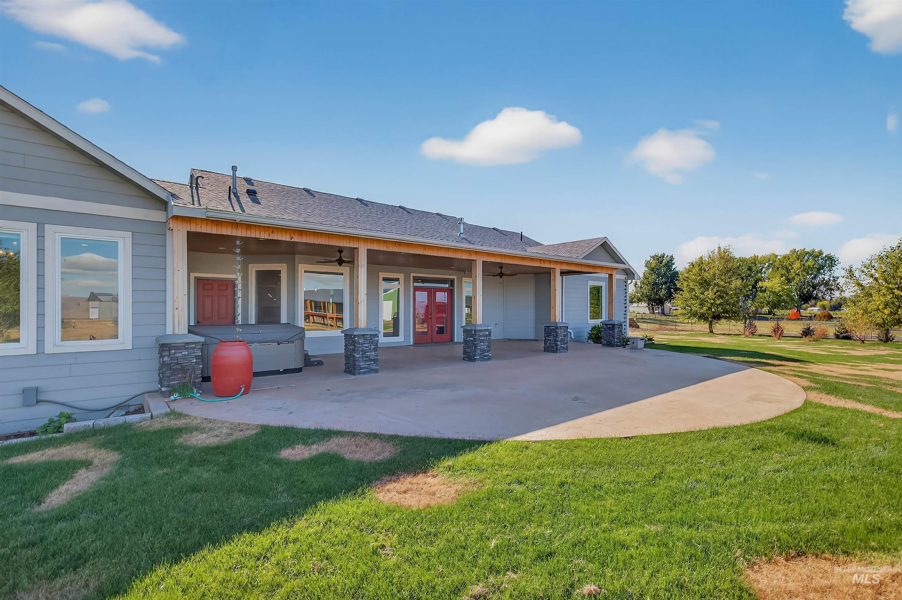2233 Burrell Avenue Lewiston, ID 83501 - Photo 4 of 48 Rear view of house with a ceiling fan, a yard, french doors, and roof with shingles