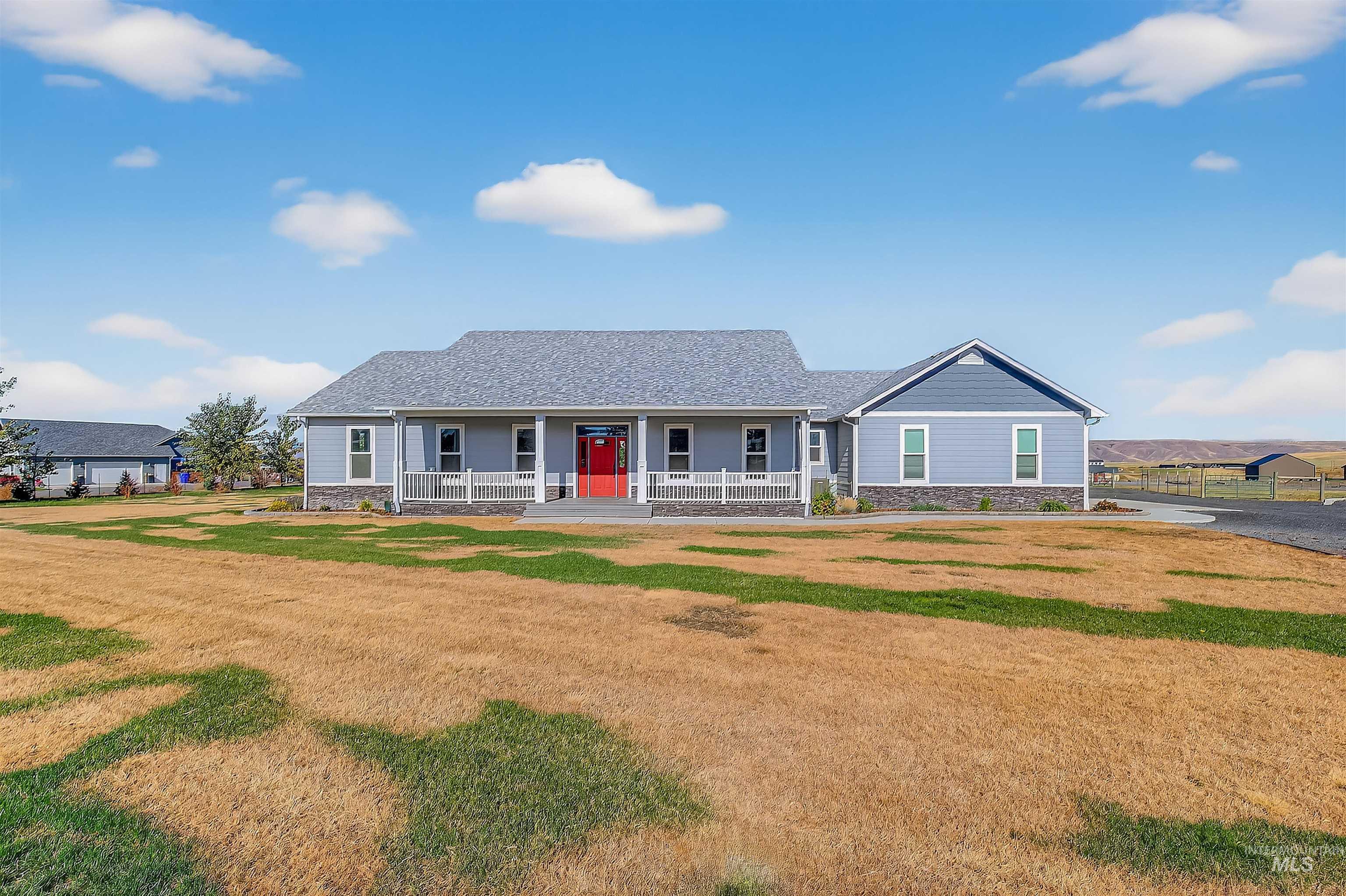 2233 Burrell Avenue Lewiston, ID 83501 - Photo 42 of 48 Ranch-style house with stone siding, a front lawn, covered porch, and a shingled roof