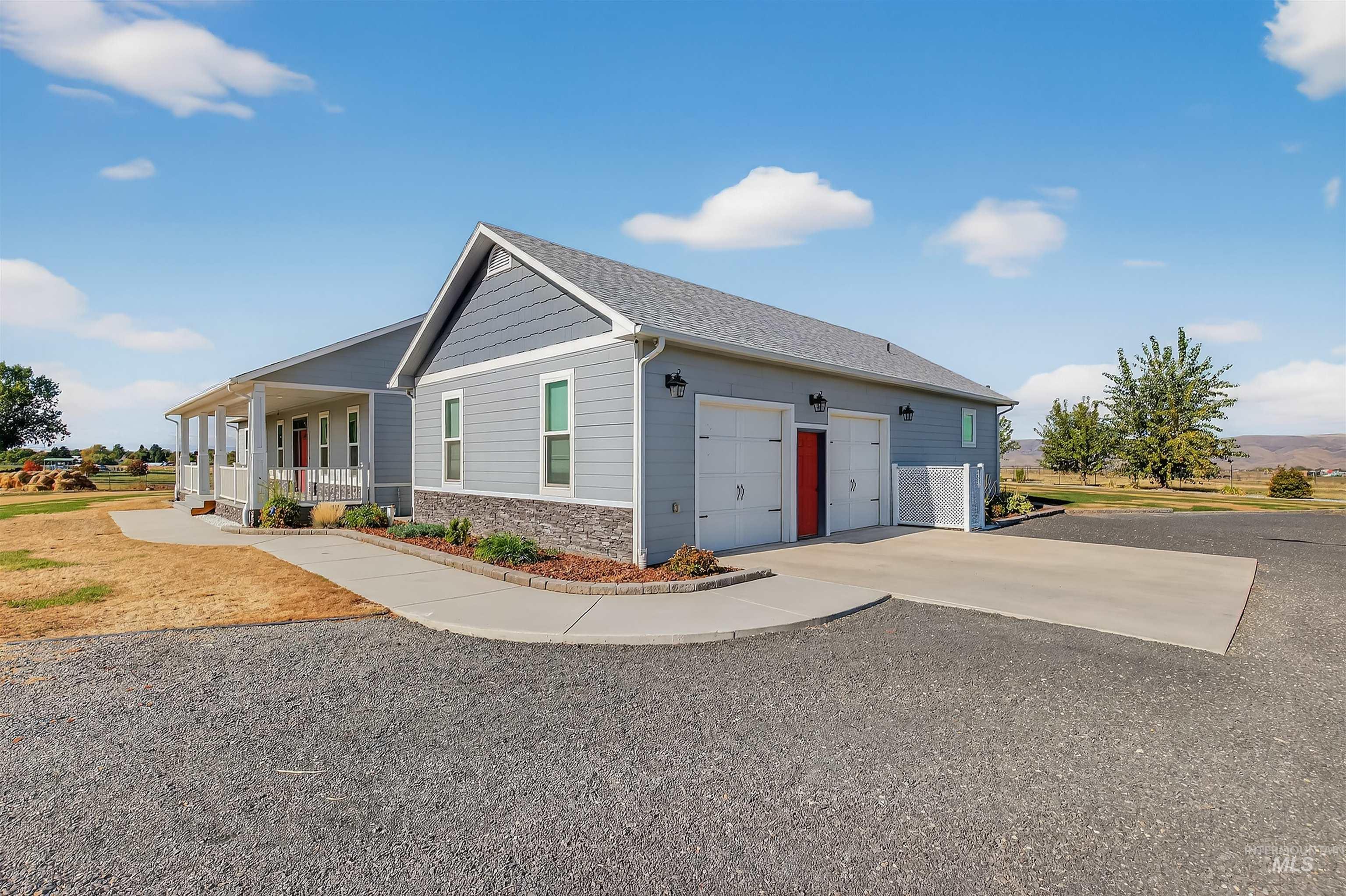 2233 Burrell Avenue Lewiston, ID 83501 - Photo 5 of 48 View of side of home with covered porch, driveway, stone siding, and a garage