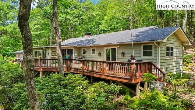 a front view of a house with garden and deck