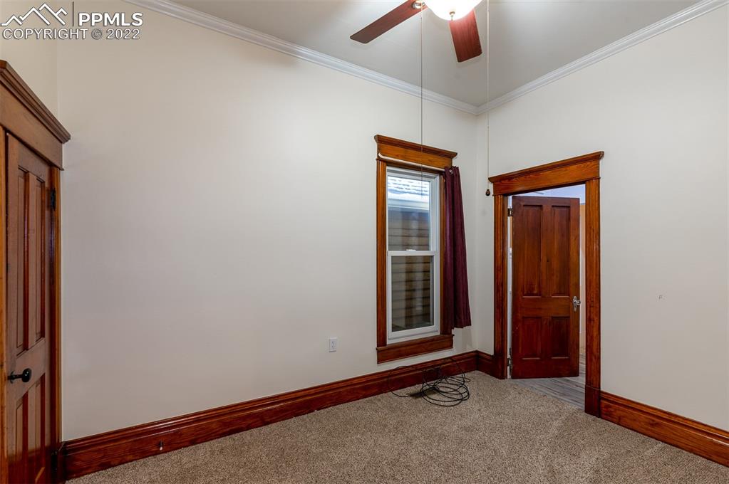 210 South 2nd Street Victor, CO 80860 - Photo 15 of 30 an empty room with window closet and chandelier fan