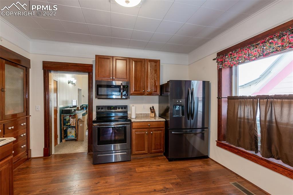 210 South 2nd Street Victor, CO 80860 - Photo 18 of 30 a kitchen with stainless steel appliances granite countertop a refrigerator and a stove top oven