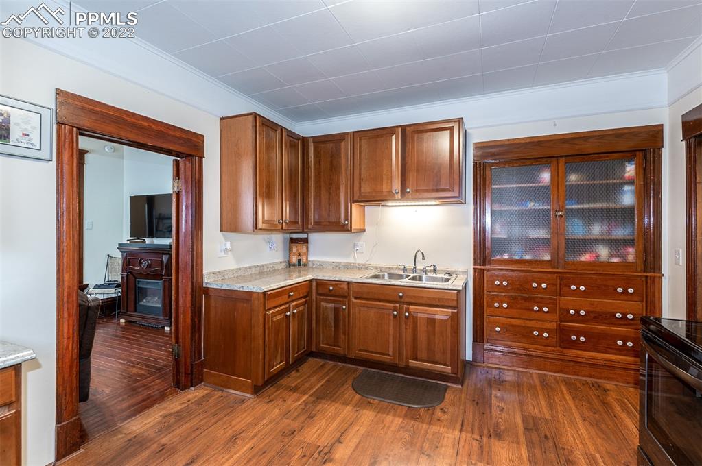 210 South 2nd Street Victor, CO 80860 - Photo 20 of 30 a kitchen with sink cabinets and wooden floor