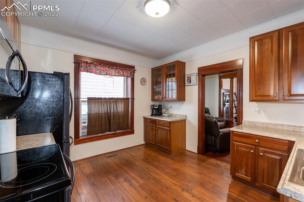 210 South 2nd Street Victor, CO 80860 - Photo 21 of 30 a kitchen with stainless steel appliances granite countertop a stove top oven a sink with granite countertops and cabinets