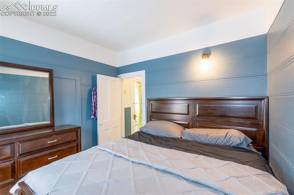 210 South 2nd Street Victor, CO 80860 - Photo 28 of 30 a bedroom with a bed and a night stand