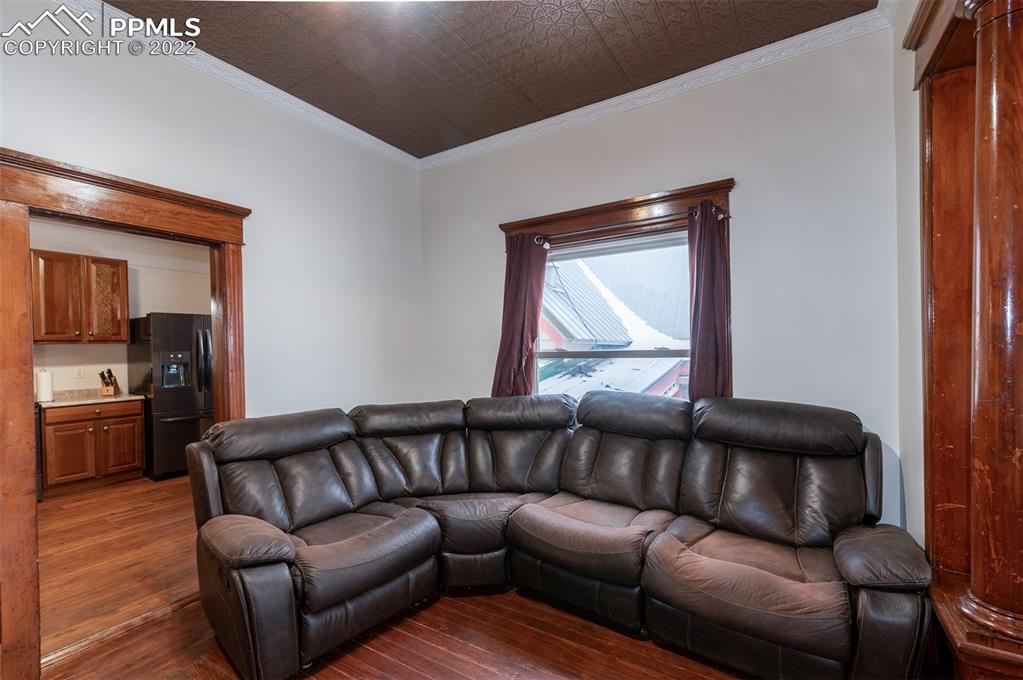 210 South 2nd Street Victor, CO 80860 - Photo 9 of 30 a living room with a couch and a stove
