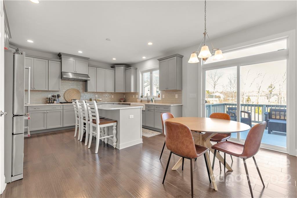 6028 Candlestick Lane Lancaster, SC 29720 - Photo 12 of 34 a dining room with stainless steel appliances granite countertop a stove a refrigerator a kitchen island a dining table and chairs