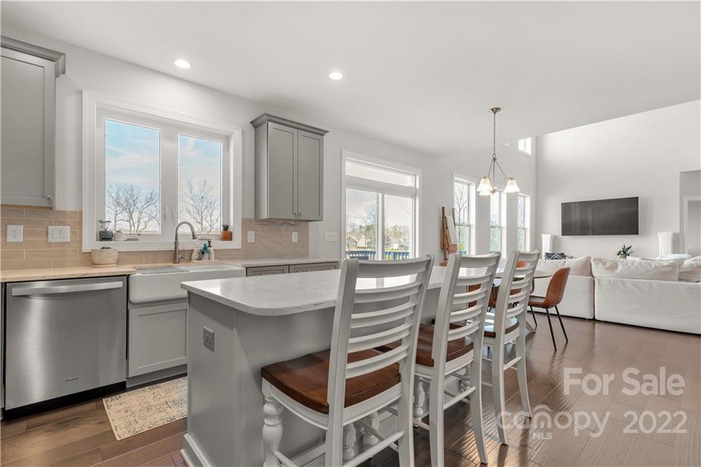 6028 Candlestick Lane Lancaster, SC 29720 - Photo 13 of 34 a kitchen with stainless steel appliances granite countertop a stove a sink dishwasher and a refrigerator with wooden floor